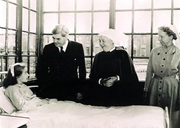 Aneurin Bevan talks to the NHS's first patient Sylvia Diggory, 13, at Trafford General Hospital in 1948. Picture: Trafford Healthcare NHS Trust/PA