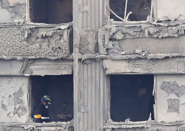 Fire service personnel inside Grenfell Tower. Picture: Rick Findler/PA Wire