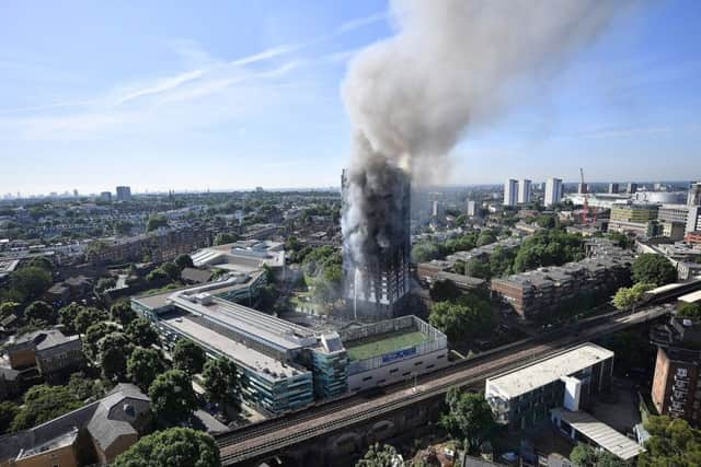 Smoke rises from the building after a huge fire engulfed the 24 story Grenfell Tower in Latimer Road, West London.  (Photo by Leon Neal/Getty Images)