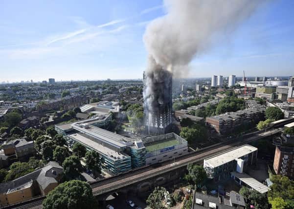 Smoke rises from the building after a huge fire engulfed the 24 story Grenfell Tower in Latimer Road, West London.  (Photo by Leon Neal/Getty Images)