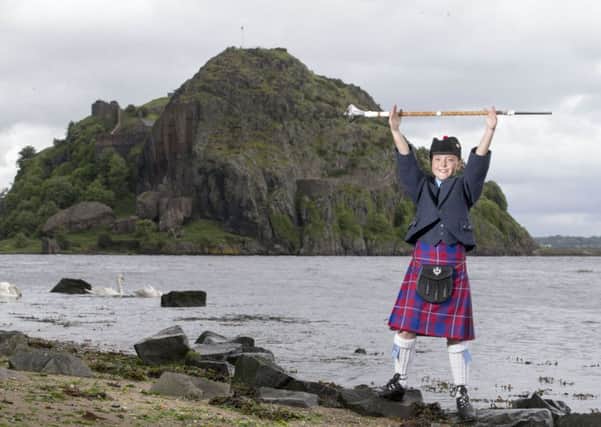 Beth Turner, 10, is barely as tall as the mace she carries - but she's ready for the Scottish Pipe Band Championships next month. Picture: Jeff Holmes