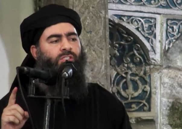The  leader of the Islamic State group, Abu Bakr al-Baghdadi, delivering a sermon at a mosque in Iraq during his first public appearance.  (AP Photo/Militant video, File)