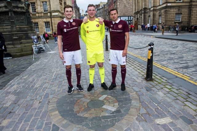 Hearts players John Souttar, Jack Hamilton, and Don Cowie launch their new home kit on the Royal Mile by the Heart of Midlothian. Picture: Bill Murray/SNS