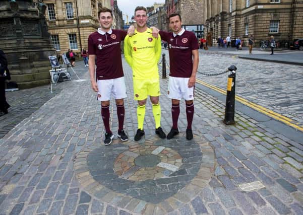 Hearts players John Souttar, Jack Hamilton, and Don Cowie launch their new home kit on the Royal Mile by the Heart of Midlothian. Picture: Bill Murray/SNS