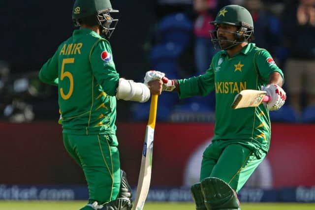 Pakistan's Mohammad Amir, left, celebrates with Sarfraz Ahmed after beating Sri Lanka. Picture: Geoff Caddick/AFP/Getty Images
