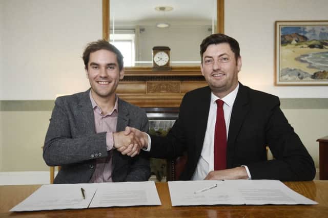 Councillor Adam McVey of the SNP, left, and Councillor Cammy Day of Labour sign a coalition agreement at the City Chambers. Picture: Greg Macvean