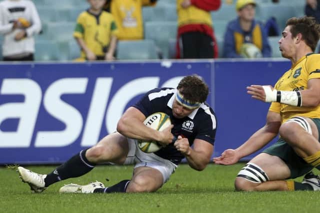Scotland's Hamish Watson scores a try in front of Australia's Richard Hardwick. Picture: AP Photo/Rick Rycroft
