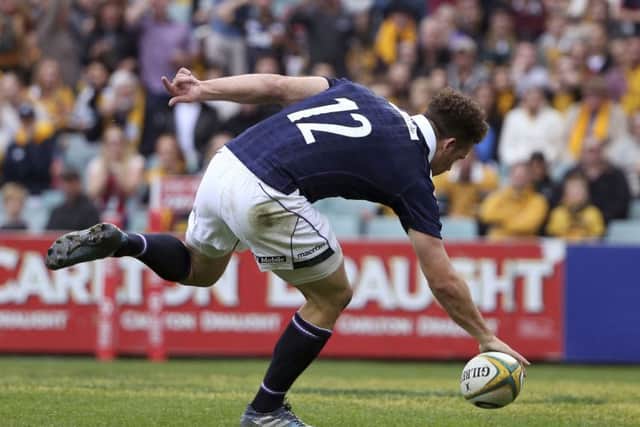 Scotland's Duncan Taylor touches the ball down to score a try. Picture: AP Photo/Rick Rycroft
