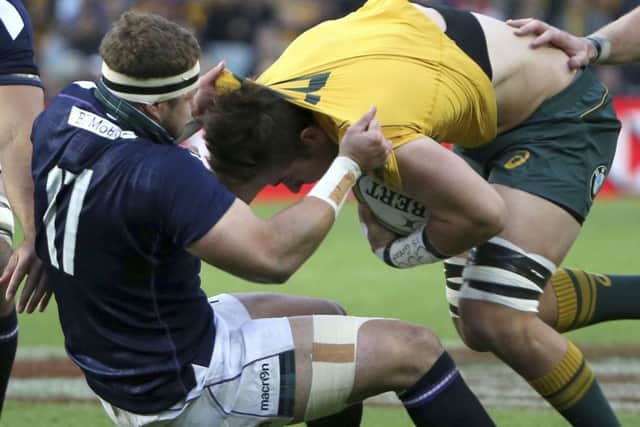 Scotland's Allan Dell tackles Australia's Richard Hardwick. Picture: Rick Rycroft/AP