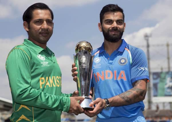 Pakistans captain Sarfraz Ahmed, left, with his Indian opposite number Virat Kohli, will battle to keep hold of the ICC trophy at the Oval today. Photograph:  AP