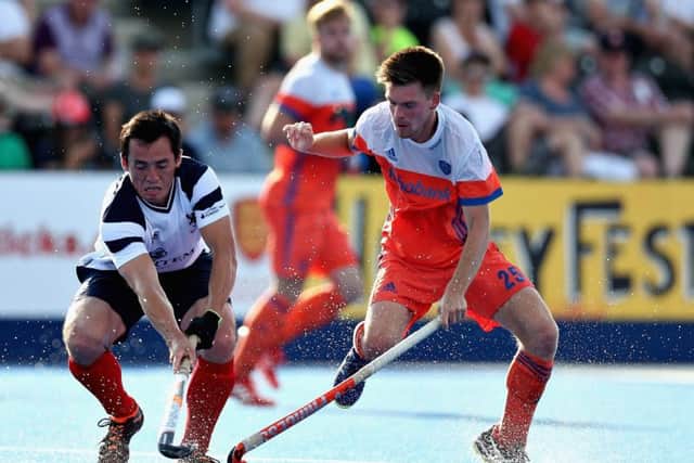 Wei Adams of Scotland battles for the ball with Thierry Brinkman of the Netherlands.  Photograph: Alex Morton/Getty Images