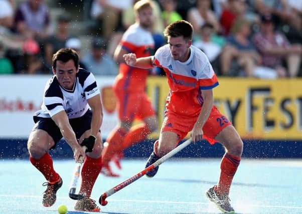 Wei Adams of Scotland battles for the ball with Thierry Brinkman of the Netherlands.  Photograph: Alex Morton/Getty Images