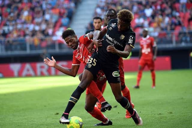 Lens defender Jean-Kevin Duverne, right, is said to be a target of Celtic. Picture: AFP/Getty