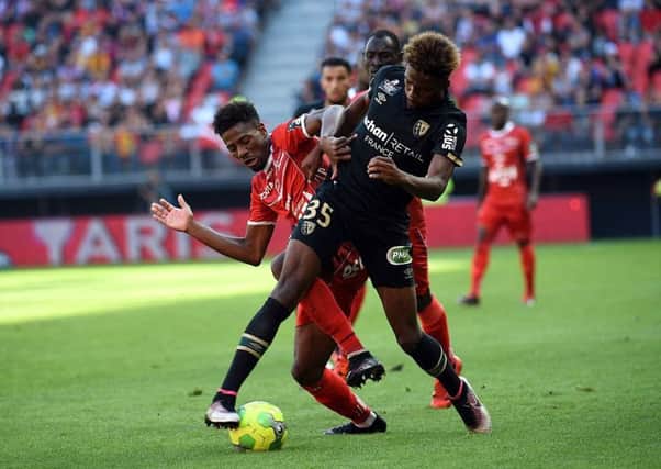 Lens defender Jean-Kevin Duverne, right, is said to be a target of Celtic. Picture: AFP/Getty