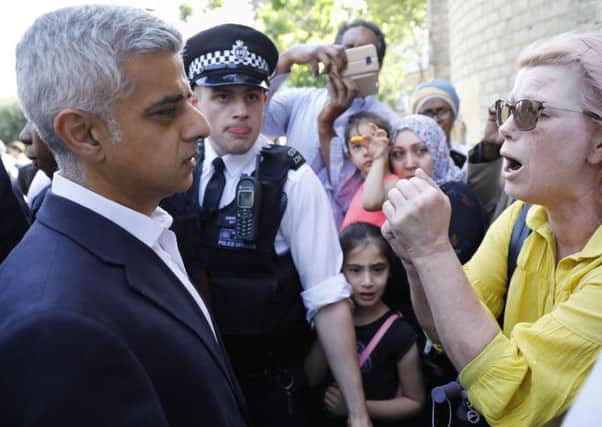 Mayor of London Sadiq Khan meets residents while visiting Grenfell Tower. AFP PHOTO / Tolga AKMENTOLGA AKMEN/AFP/Getty Images