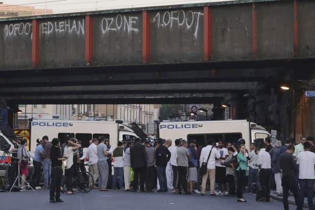 People and media gather at a police cordon on Seven Sisters Road near Finsbury Park station. (AP Photo/Tim Ireland)