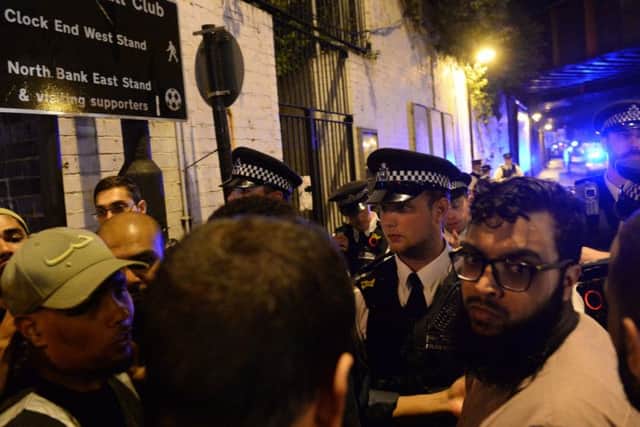 Police officers talk with local people at Finsbury Park in north London. Picture: Yui Mok/PA Wire