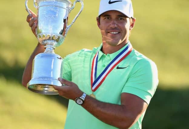 Brooks Koepka holds a loft the US Open Trophy after his victory at Erin Hills in Wisconsin. Picture: Getty Images