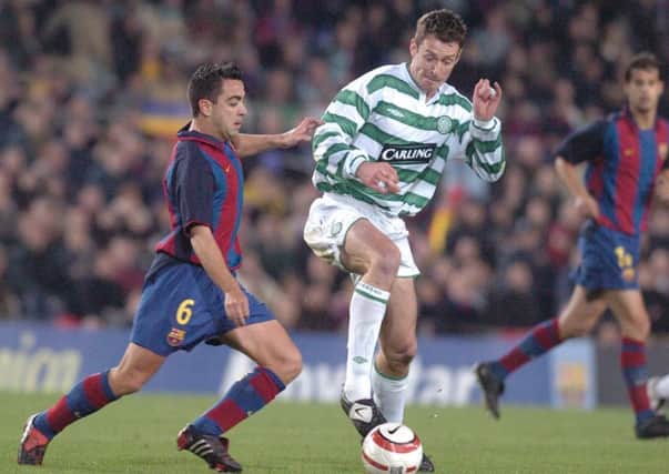 Xavi, left, squaring off against Celtic in 2004. Picture: Neil Hanna