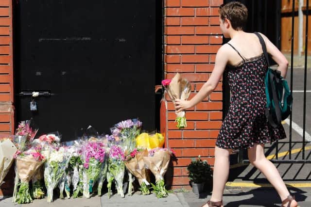 A woman lays flowers in tribute outside Finsbury Park Mosque Picture: Getty Images