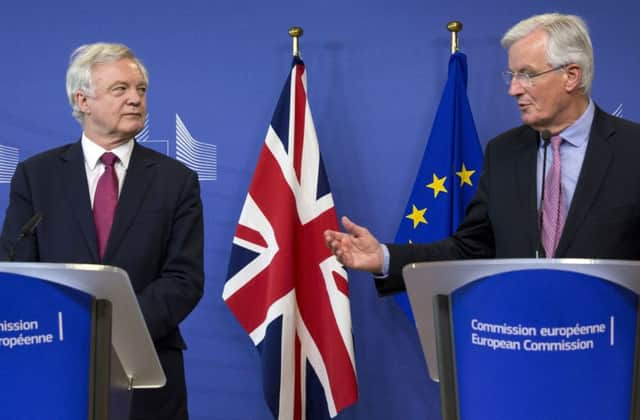 EU Chief Brexit Negotiator Michel Barnier, right, and British Secretary of State David Davis make statements as they arrive at EU headquarters in Brussels. Picture: AP Photo/Virginia Mayo
