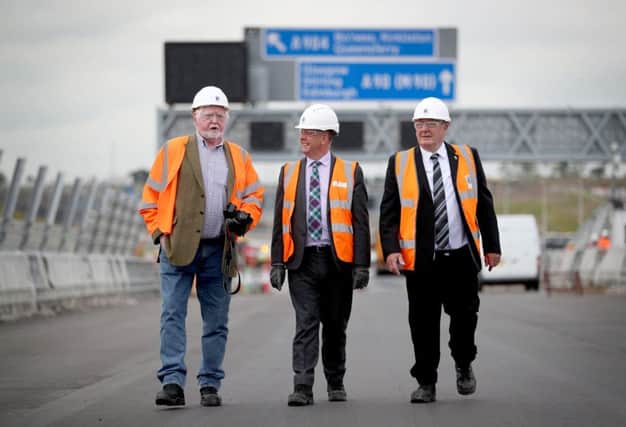 Economy secretary Keith Brown MSP (centre) with retired engineers who worked on the Forth Road Bridge over 50 years ago Alex Porteous, 71, (left) and George Barnett, 72, on the road deck of the Queensferry Crossing. Picture: Jane Barlow/PA Wire