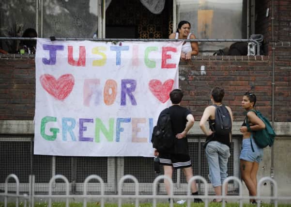 A banner with "Justice for Grenfell" is seen close to the scene of the tower block fire. Picture: AFP/Tolga Akmen/Getty Images