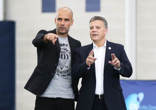 New Rangers director of football Mark Allen with Manchester City manager Pep Guardiola. Picture: PA Archive/PA Images