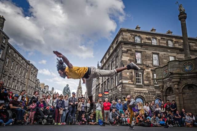 Le Patin Libre from Canada promote their ice show on rollor skates on the Royal Mile; their show Vertival Influences at Murrayfield Ice Rink part of the Edinburgh Fringe Festival. credit steven scott taylor / J P License