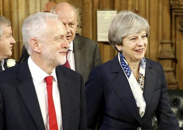 Theresa May arrives for the Queen's Speech alongside Jeremy Corbyn.