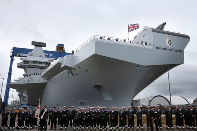 HMS Queen Elizabeth in Rosyth dockyard as Queen Elizabeth II formally names the ship in 2014. Picture: Andrew Milligan/PA