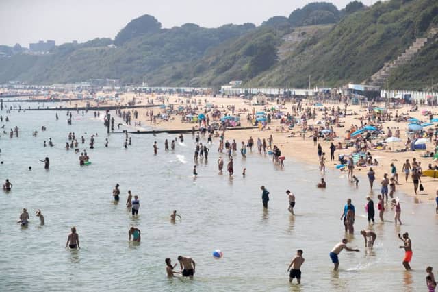 People enjoy the hot weather on the beach in Bournemouth, Dorset, as temperatures soar across England and Wales. Picture: PA