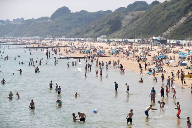 People enjoy the hot weather on the beach in Bournemouth, Dorset, as temperatures soar across England and Wales. Picture: PA