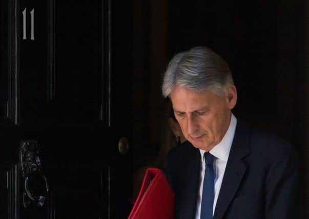 Economists say Chancellor Philip Hammond faces 'tough challenges' to achieve a balanced budget by 2025. Picture: Daniel Leal-Olivas/AFP/Getty Images