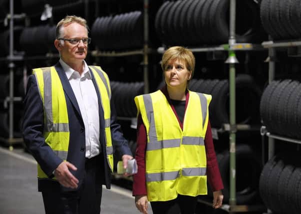 Michelin factory manager John Reid with First Minister Nicola Sturgeon at the Dundee tyre plant. Picture: Andy Buchanan - Pool/Getty Images