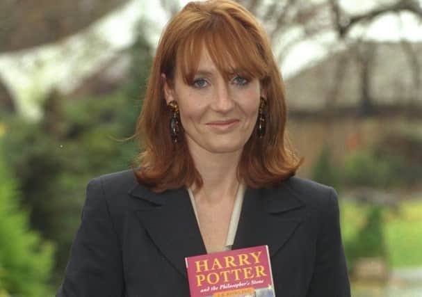 JK Rowling with a first edition in 1997. Picture: Mark Beltran/Daily Mail/REX/Shutterstock