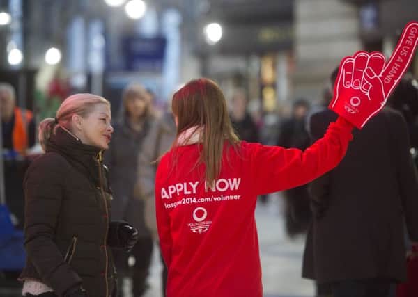 A volunteer at the 2014 Commonwealth Games gives advice at Glasgow Central Station. Picture: SNS