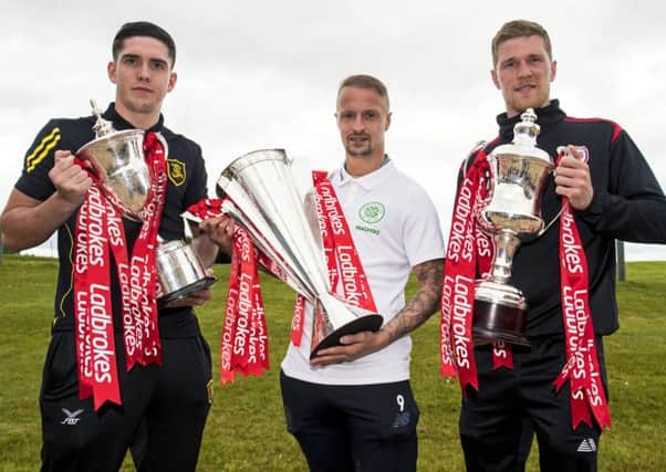 Livingston's Jackson Longridge, Celtic's Leigh Griffiths, and Arbroath's Colin Hamilton help launch the Ladbrokes Premiership, League 1, and League 2 fixtures for the upcoming season. Picture: SNS