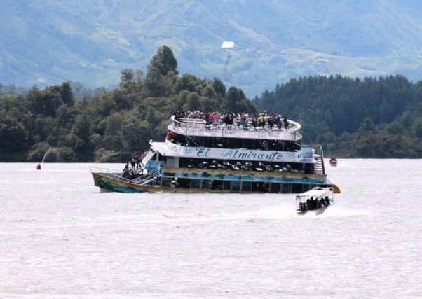 A tourist boat packed with passengers for the holiday weekend sunk, leaving at least six people dead and 15 missing. Picture: Juan Quiroz via AP