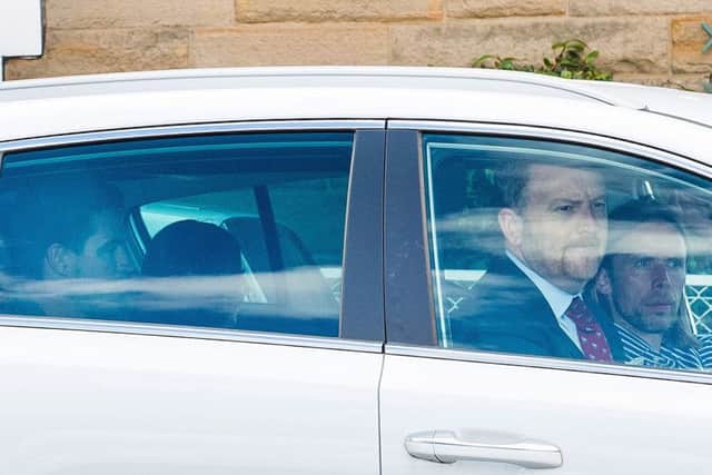 Kyle Lafferty, pictured in the back seat, on his way to Tynecastle for Hearts talks with the club's chief operating officer Scot Gardiner and assistant manager Austin MacPhee. Picture: Ross Parker/SNS