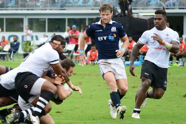 Ross Ford drives through the Fiji defence to score a try during their test in Suva. Picture: IVAMERE ROKOVESA/AFP/Getty Images