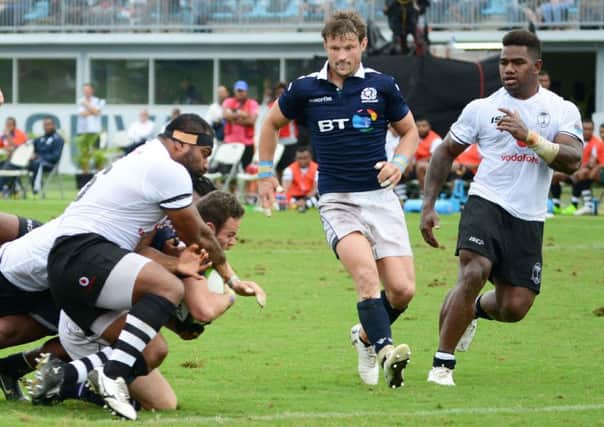 Ross Ford drives through the Fiji defence to score a try during their test in Suva. Picture: IVAMERE ROKOVESA/AFP/Getty Images