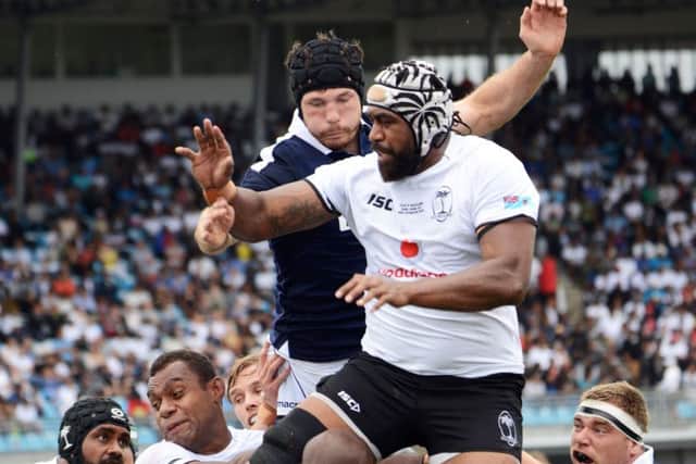 Opening try scorer Peceli Yano gets in front of Tim Swinson. Picture: AFP/Getty