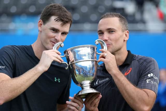 Jamie Murray, left, and Bruno Soares kiss the trophy at Queens following their 6-2, 6-3 triumph. Picture: PA.