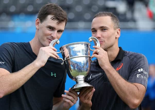 Jamie Murray, left, and Bruno Soares kiss the trophy at Queens following their 6-2, 6-3 triumph. Picture: PA.