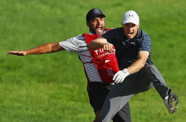 Jordan Spieth and caddie Michael Greller celebrate after his holed bunker shot in the Travelers Championship. Picture: Getty Images