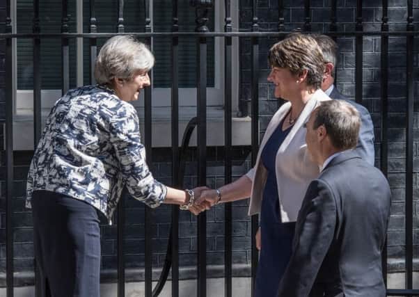 It's a deal: Theresa May greets Arlene Foster and the DUP contingent at Downing Street.