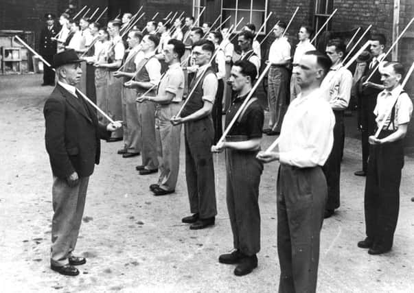 Members of the Civicorps  men who were waiting to be called up  train with broomsticks in place of rifles in June 1940. Lowe challenges the notion that Britain stood alone in the fight against Germany at this point in the war. Picture: Fox Photos/Hulton Archive/Getty Images