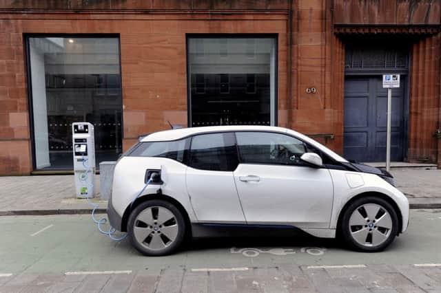An electric car at a charging station. Picture: John Devlin