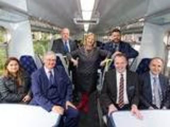 East Kilbride SNP MSP Linda Fabiani, centre, with rail officials on board the first train with new seats today. Picture: Transport Scotland